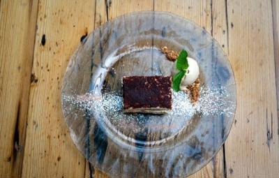 A layered dessert slice with ice cream
