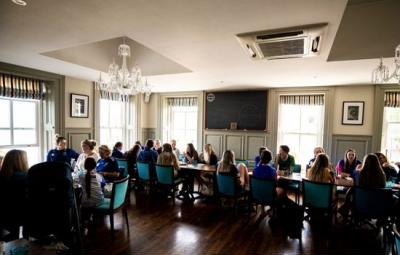 A large group dining in the upstairs room