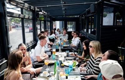 A long table of friends on the terrace